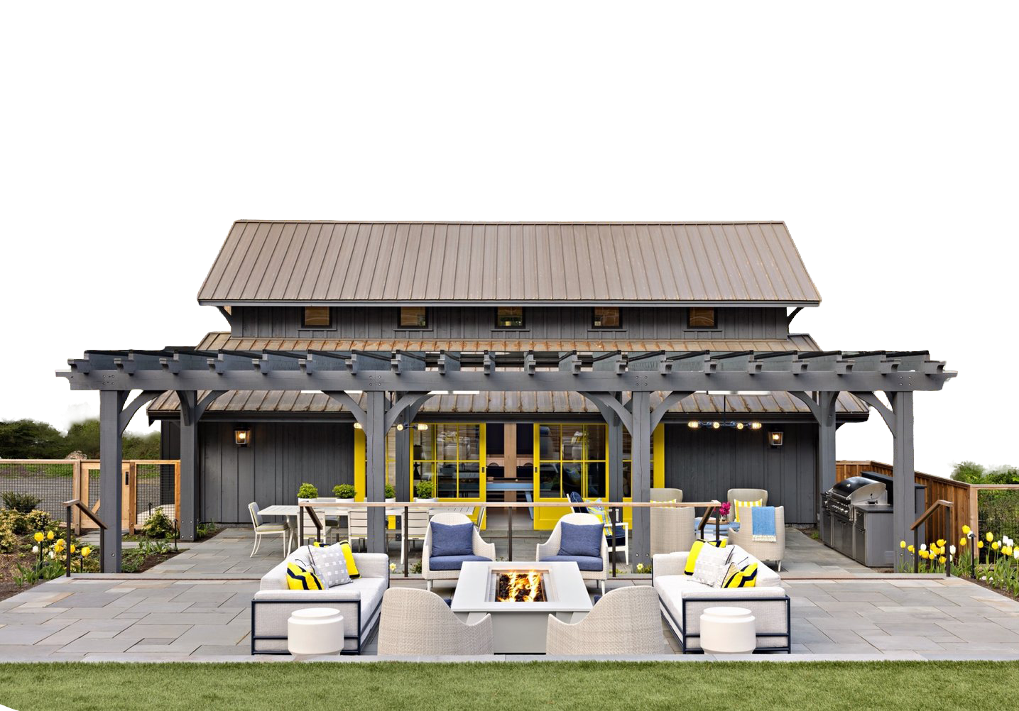 A patio with a fire pit, outdoor sofa, and dining area in front of a gray house with yellow doors and a wooden pergola, as seen in our windows doors and more gallery.